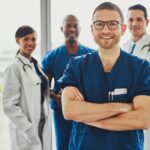 Confident doctor in front of group