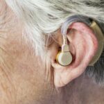 Elderly woman wearing a hearing aid